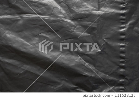 transparent plastic bag wrap overlay texture on black background 111528125
