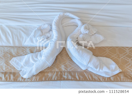 Clean white bath towels on the hotel bed Clean white bath towels on the hotel bed 111528654