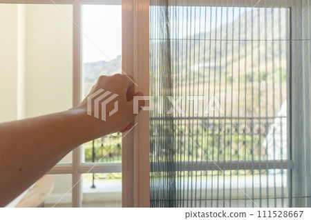 Hand hold pleated mosquito net wire screen handle on house window 111528667