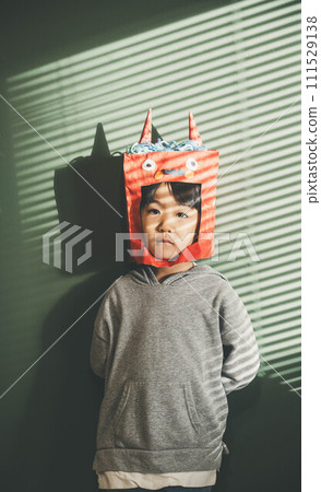 A child enjoys Setsubun wearing a demon headgear 111529138