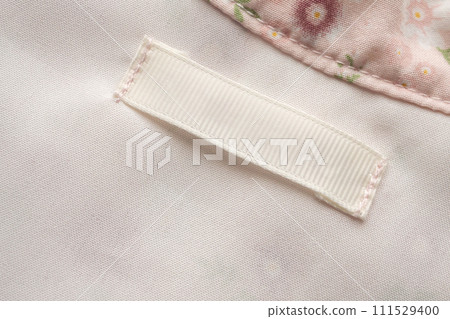 Blank laundry care clothes label on fabric texture background 111529400