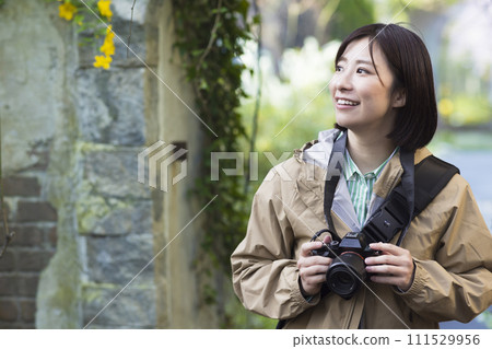 A woman traveling with a camera 111529956