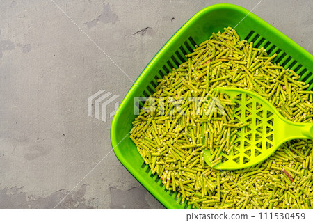 Pet litter tray with wooden filler on gray background Pet litter tray with wooden filler on gray background 111530459