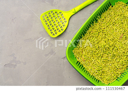 Pet litter tray with wooden filler on gray background 111530467