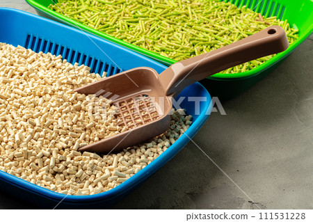 Pet litter tray with wooden filler on gray background 111531228