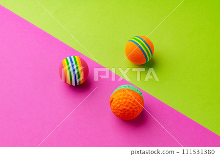 Pet toys balls on pink and green background studio shot Pet toys balls on pink and green background studio shot 111531380