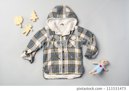 Warm baby coat for boys on gray background top view Warm baby coat for boys on gray background top view 111531473
