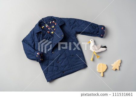 Warm baby coat for boys on gray background top view Warm baby coat for boys on gray background top view 111531661