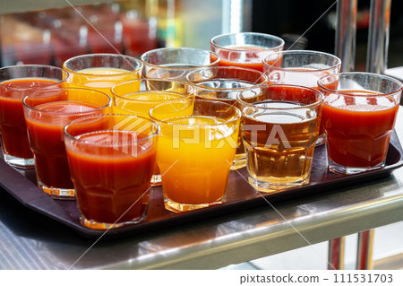 Glasses of juice on display on the table in a canteen 111531703
