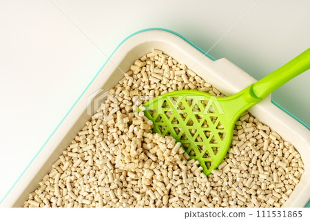 Wooden pet litter filler with scoop isolated on white background Wooden pet litter filler with scoop isolated on white background 111531865