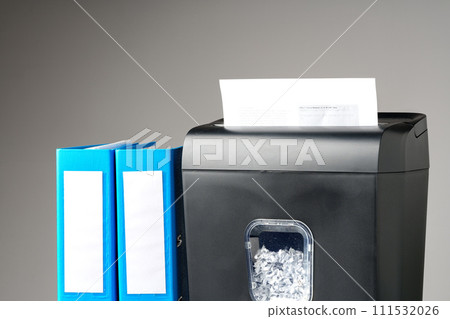 Office paper shredder on table against gray background 111532026
