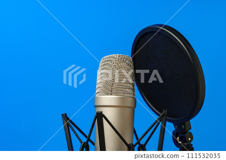 Professional microphone stand over blue studio background 111532035