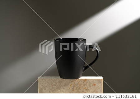 Black cup shadow sun light against gray background 111532161