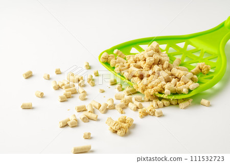 Wooden pet litter filler with scoop isolated on white background Wooden pet litter filler with scoop isolated on white background 111532723