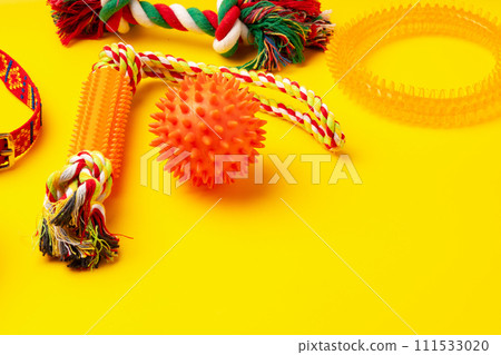 Pet toys on yellow background studio shot 111533020