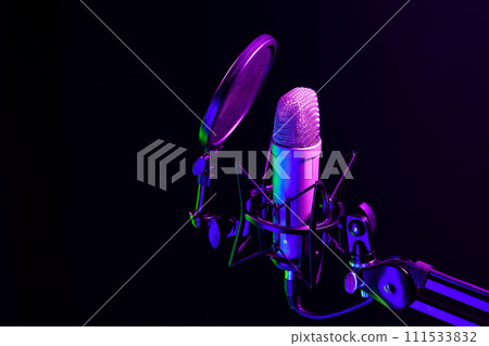 Professional microphone against black background in studio Professional microphone against black background in studio 111533832