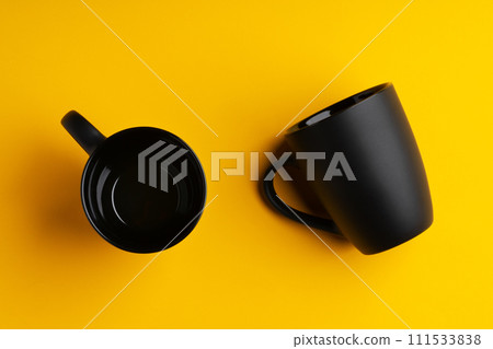 Two mugs on yellow studio background close up Two mugs on yellow studio background close up 111533838