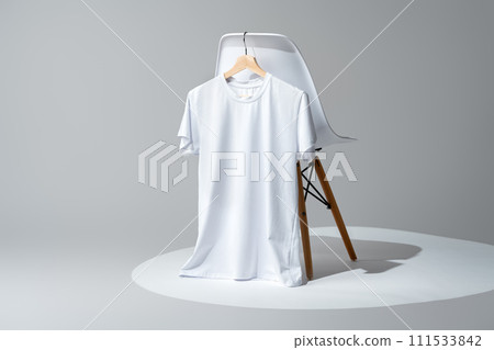 White blank t-shirt hanging on chair in empty room White blank t-shirt hanging on chair in empty room 111533842