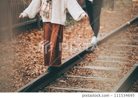 The feet of a couple walking across a railroad crossing (abandoned railway) The feet of a couple walking across a railroad crossing (abandoned railway) 111534695