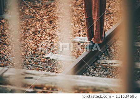 A woman's feet crossing the railway (disused railway) 111534696