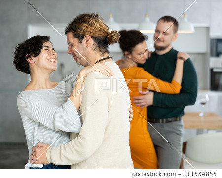 Men and women dancing during house party. Men and women dancing during house party. 111534855