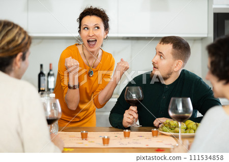 Group of friends is playing board game. Group of friends is playing board game. 111534858