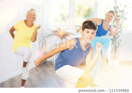 Happy preteen boy practicing dance positions during workout session 111534960