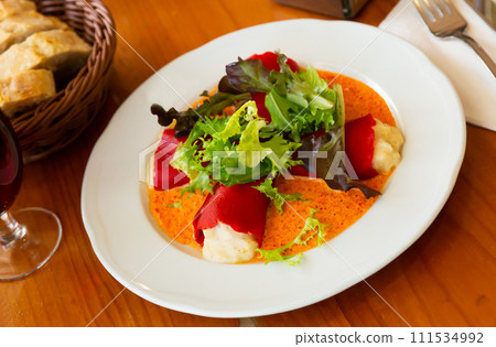Stuffed piquillo peppers with cod brandade in sauce 111534992