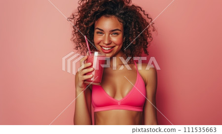 athletic woman, with defined muscles wearing sportswear, drinking a protein shake athletic woman, with defined muscles wearing sportswear, drinking a protein shake 111535663