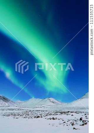 Aurora Borealis. Northern Lights over the mountains. A winter night landscape Aurora Borealis. Northern Lights over the mountains. A winter night landscape 111535715