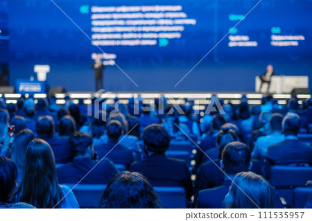 Corporate conference presentation with blurred audience and speaker 111535957