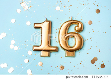 Gold candles in the form of number sixteen. Gold candles in the form of number sixteen. 111535996