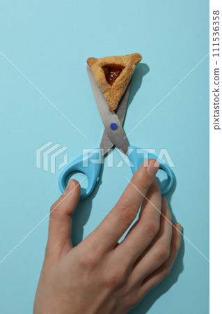 Scissors with traditional cookies, on a blue background. 111536358