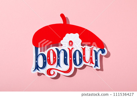 The word "bonjour" with a beret on a pink background. 111536427