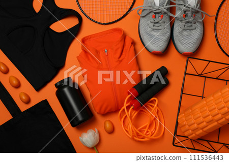 Sportswear with flowers on an orange background. Sportswear with flowers on an orange background. 111536443