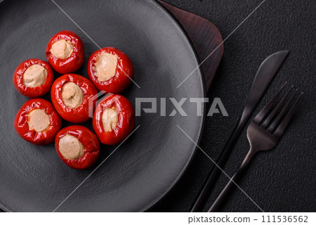 Red bell peppers stuffed with cheese or meat with salt, spices and herbs 111536562