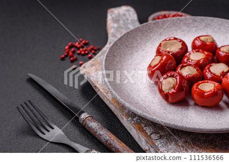 Red bell peppers stuffed with cheese or meat with salt, spices and herbs 111536566