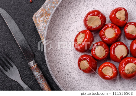 Red bell peppers stuffed with cheese or meat with salt, spices and herbs 111536568