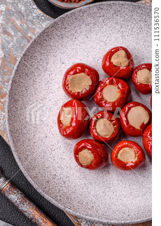Red bell peppers stuffed with cheese or meat with salt, spices and herbs 111536570