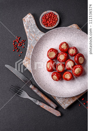 Red bell peppers stuffed with cheese or meat with salt, spices and herbs 111536574