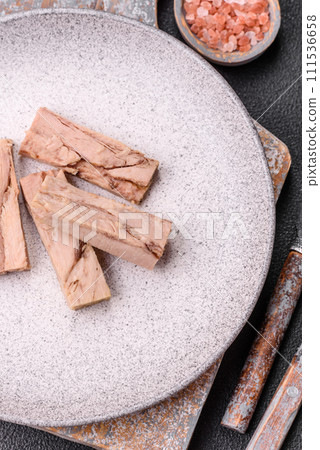 Delicious canned dietary tuna meat with salt, spices and oil 111536658