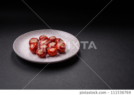 Red bell peppers stuffed with cheese or meat with salt, spices and herbs Red bell peppers stuffed with cheese or meat with salt, spices and herbs 111536769