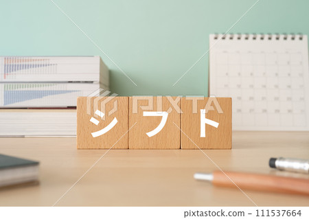 A desk with a block written as shift 111537664