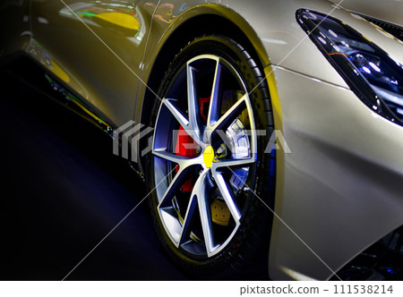 Front view of headlights modern sport car on black background Front view of headlights modern sport car on black background 111538214