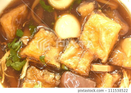 braised fish maw with bamboo shoot topping boiled egg in red gravy soup on bowl 111538522