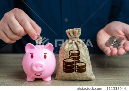 Accumulation of money. Putting coins in a piggy bank. Banks and finance. Investments, fundraising. Savings management. Savings and accumulation of funds from cutting expenses. Accumulation of money. Putting coins in a piggy bank. Banks and finance. Investments, fundraising. Savings management. Savings and accumulation of funds from cutting expenses. 111538944