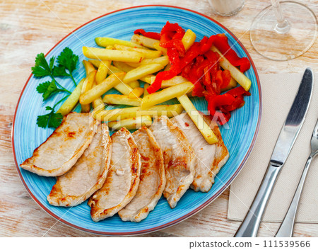 Pork loin with fried potato and pimiento on plate 111539566