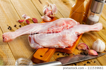 Preparation of raw goatling shoulder meat on cutting board 111539661