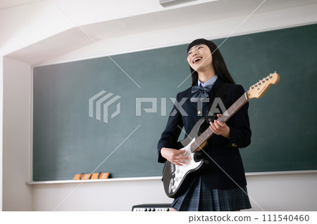 Students singing while playing the guitar - Image of club activities for wind bands and light music 111540460