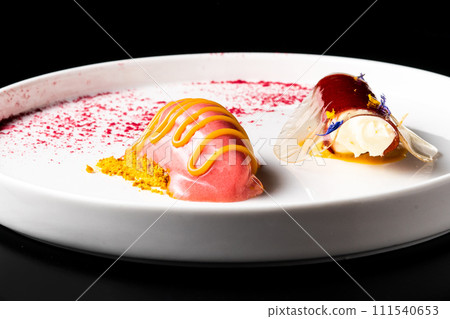 Italian Sicilian cannolo dessert closeup on white plate macro with crust and ricotta cheese Italian Sicilian cannolo dessert closeup on white plate macro with crust and ricotta cheese 111540653